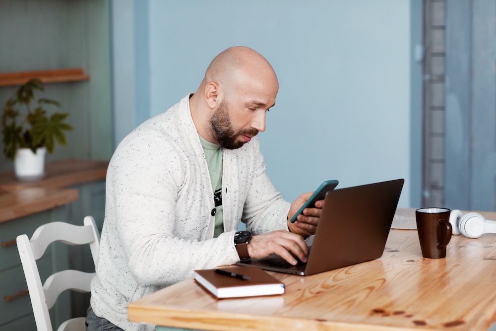 An attractive man is discussing business with business partners on the phone. Business, work