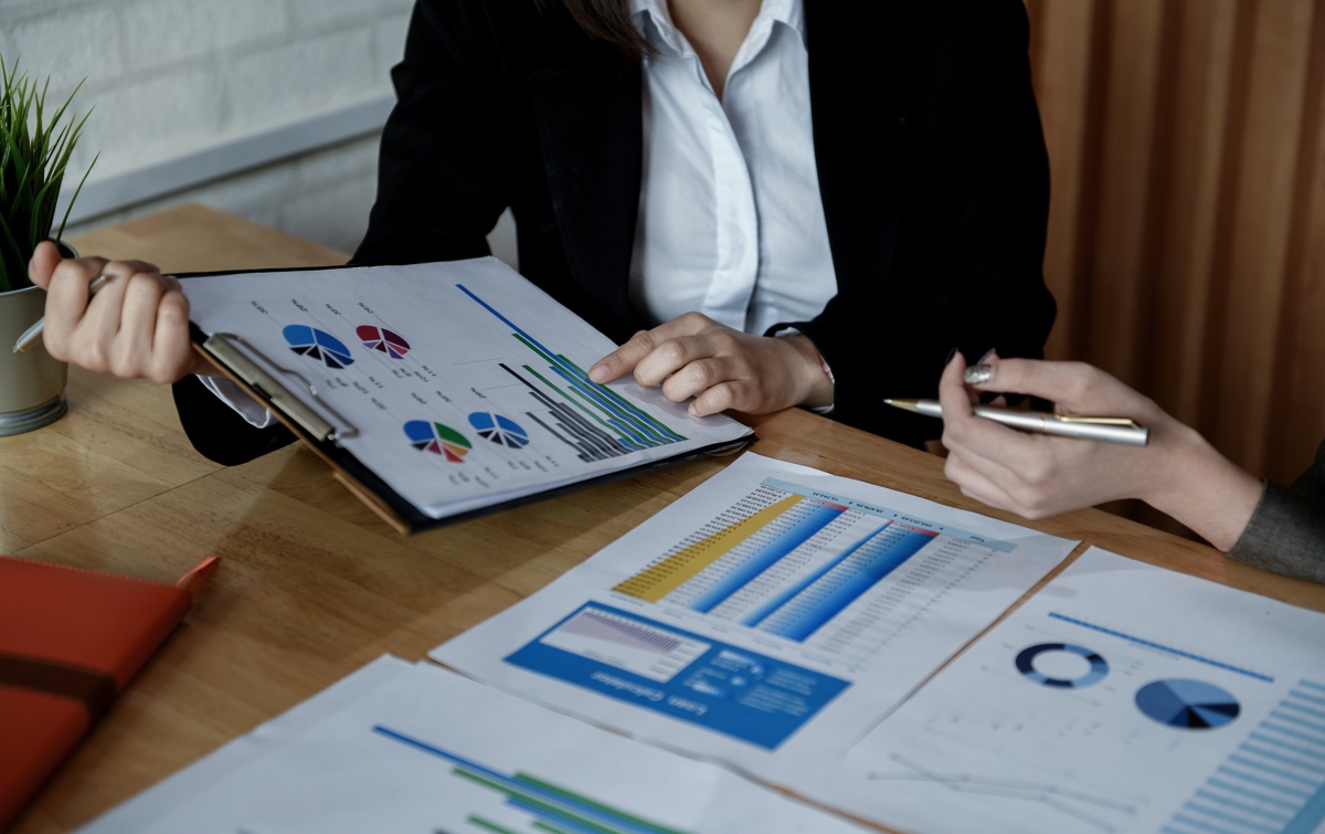 Team of female accountants are working on data documents in the office.